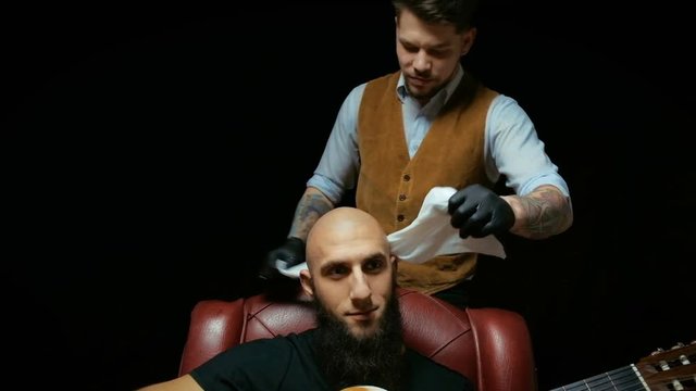 Close-up of a using clippers to shave head.