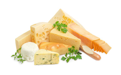 Several various types of cheese and twigs of parsley