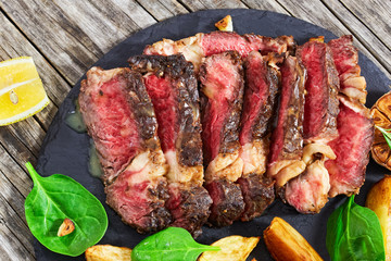 medium-rare grilled ribeye steak with fried potato