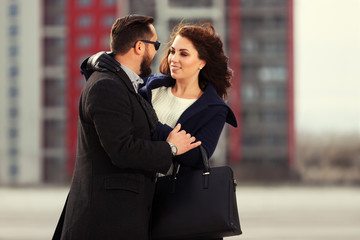 Young fashion couple in love walking on city street