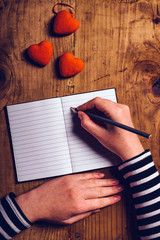 Woman writing love letter card for Valentines day