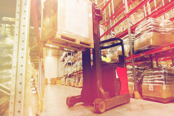 man on forklift loading cargo at warehouse