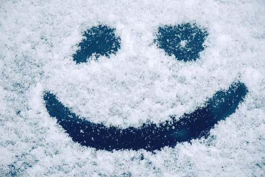 Happy smiley emoticon face in snow