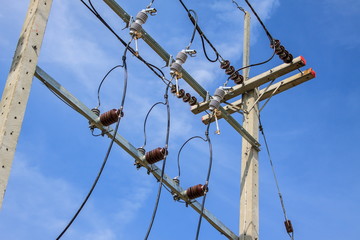 Electric pole with wires on a background of blue sky
