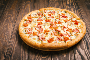 Delicious pizza with mushrooms and ham