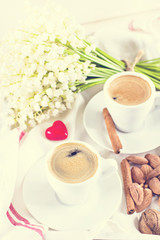 espresso, nuts and bouquet of flowers