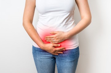 Woman with menstrual pain is holding her aching belly