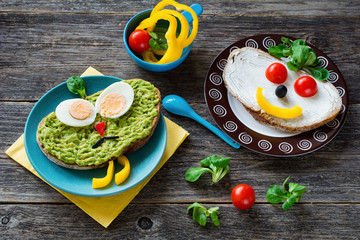 Kids healthy meal, colorful and funny faces with vegetables and fruits on bread. Children breakfast or snack