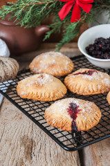Blueberry hand pies sprinkled with sugar on wooden table