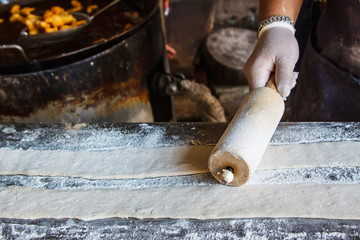 Rolling pin with dough and flour