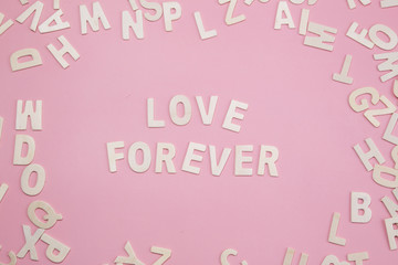 Sorting letters Love forever on pink.