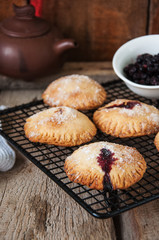 Blueberry hand pies sprinkled with sugar on wooden table