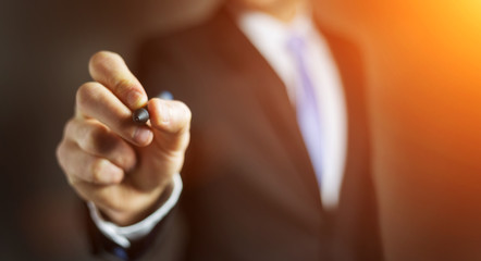 Businessman writing with a pen on a digital screen