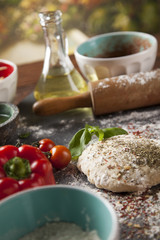 Preparing pizza with dough and tomato sauce