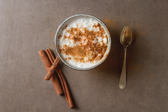 Traditional rice pudding with cinnamon. Dark background. Tasty a