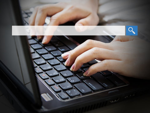 Young woman using laptop with blank search bar