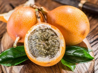 Granadilla fruits on the wooden table.
