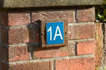 House number 1A sign
