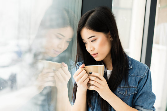 asian woman drinking coffee