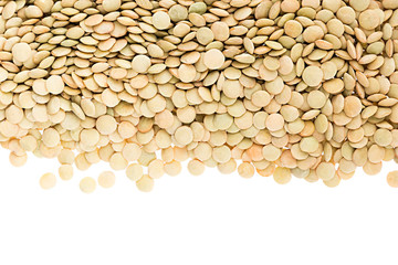 Border of green lentil closeup with copy space on white background. Isolated. Healthy protein food.