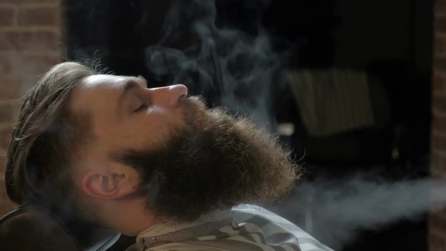 Shaving process of beards in Barbershop. Steam shave
