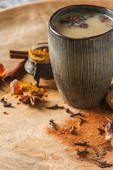 Traditional Indian masala tea in ceramic cup with spices to milk - obrazy, fototapety, plakaty