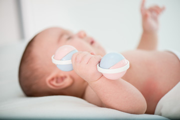 Baby with rattle toy