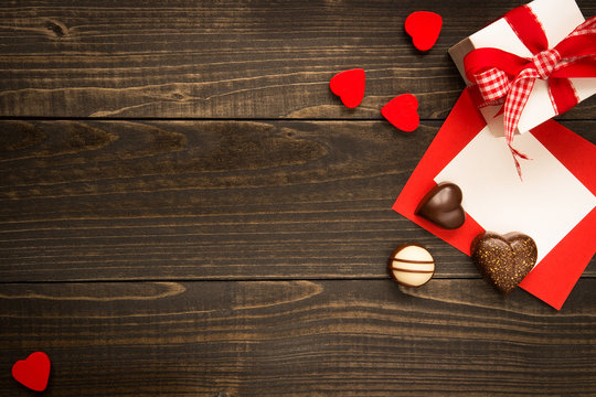 Valentine's Day background. Gift box, red hearts and Valentine's