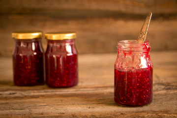 .Homemade jam with raspberry on the wooden table