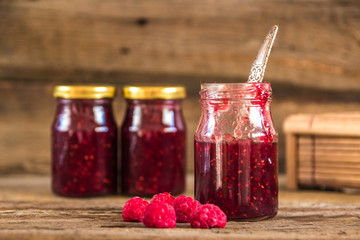 Homemade jam with raspberry on the wooden table