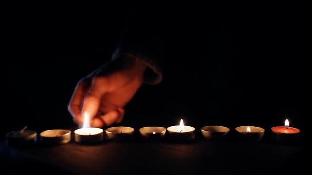 Light a lot of candles in the dark - rapid footage