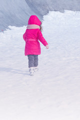 Fototapeta na wymiar Little Cute sweet girl outdoor playing in winter snow park