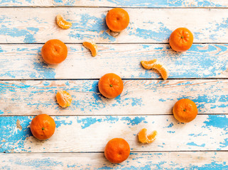 Background from mandarins on the old blue wooden table. Top view