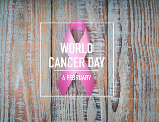World cancer day : Breast Cancer Awareness Ribbon on wood Backgr