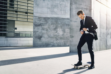 Businessman adjusting his necktie standing on skateboard