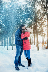 Fototapeta na wymiar Man with a woman walking in the winter snow park