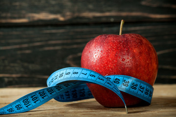 Fresh apple with measuring tape 
