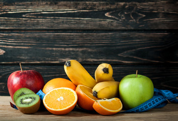 Fresh fruits and measuring tape