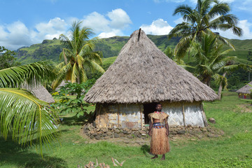 Fototapeta na wymiar Indigenous Fijian man dressed in traditional Fijian costume, sta