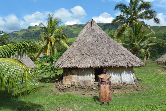Indigenous Fijian man dressed in traditional Fijian costume, sta
