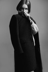 Portrait fashion model woman gray coat style pose on color background in studio
 - obrazy, fototapety, plakaty