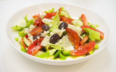 Greek salad with tomatoes, feta cheese and olives