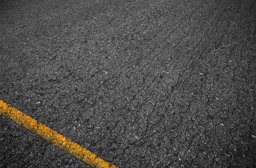 Asphalt background texture with some fine grain with Yellow Stri