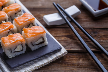 Fototapeta na wymiar Delicious fresh rolls with salmon closeup