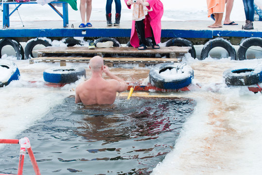 swimming in icy water, christening, baptism in Russia
