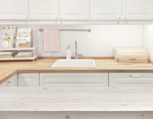 Blurred kitchen interior with wooden texture planks surface in front