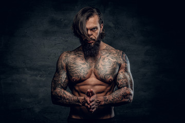 Portrait of a  man with tattooed body.
