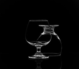 Shot of empty crystal glassware on black isolated.