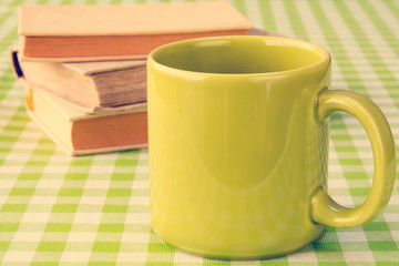 Green mug and books