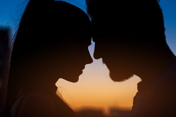 Couple face silhouette. Woman, man and evening sky. Two hearts one life.